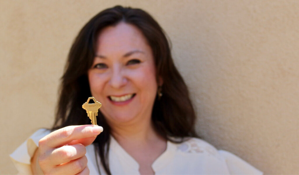 Lori Montoya holding a house key in Santa Fe, New Mexico.